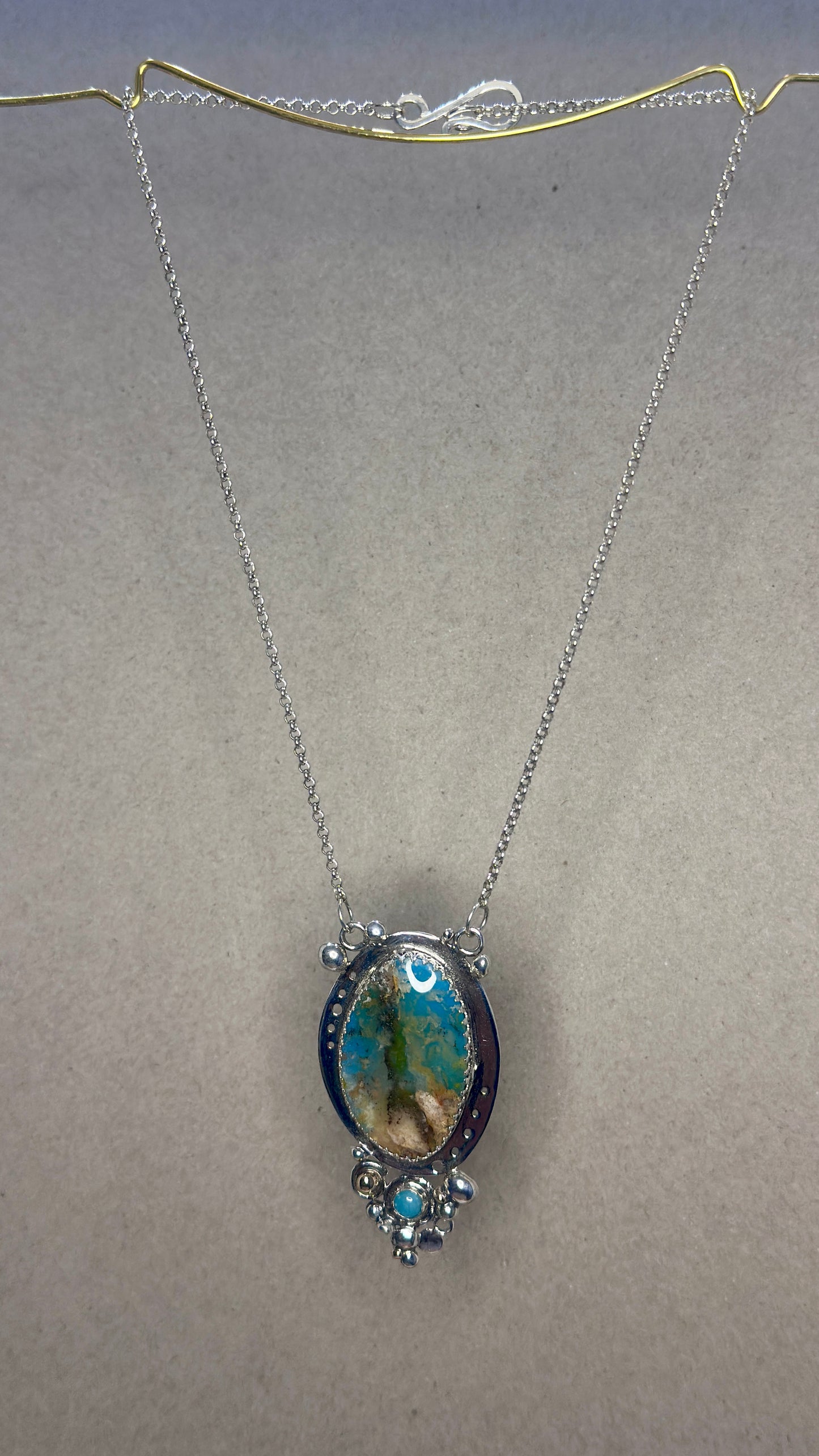Necklace with a pendant on a plain background