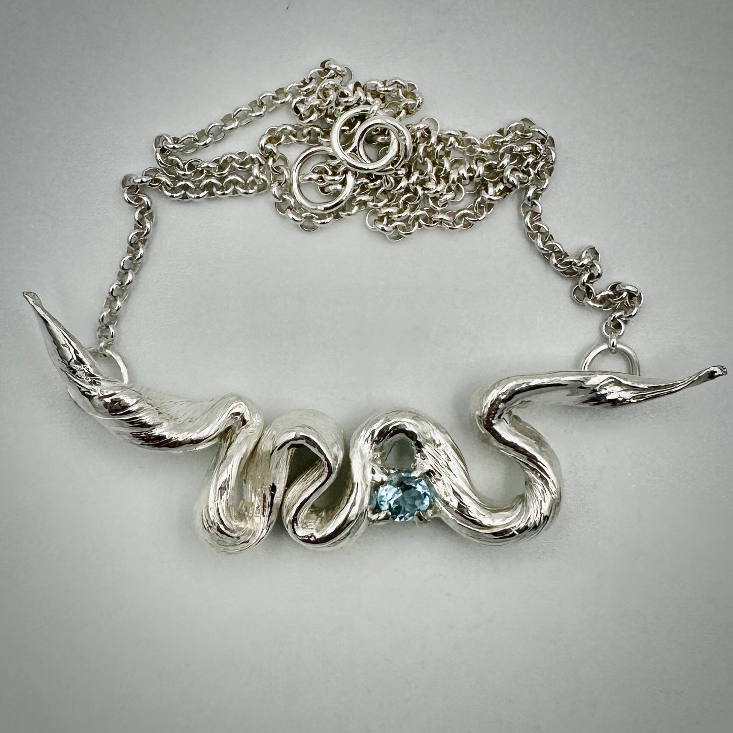 Detail of flowing sterling silver Mitsuro Hikime pendant inspired by Derby Tasmania's Hazy Days MTB trail