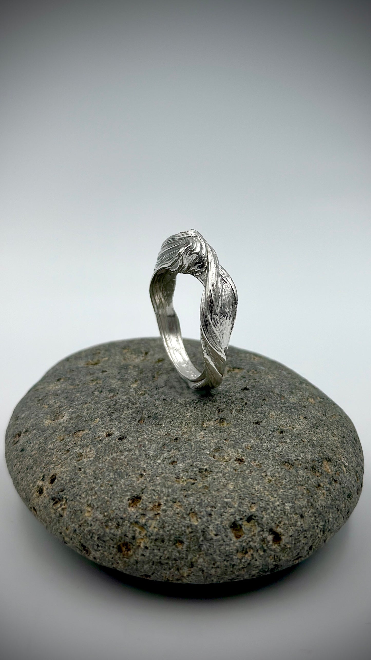 Flow State Ring side profile displaying fluid curving lines in solid sterling silver