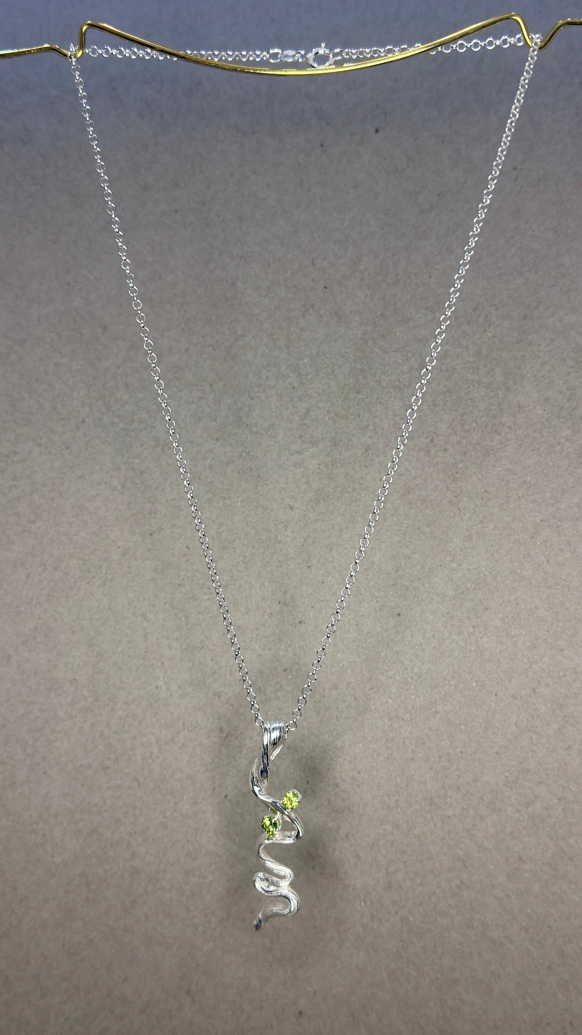 Flow State trail pendant Mitsuro Hikime flowing silver lines on Detonate trail pendant with 4mm Peridot stones