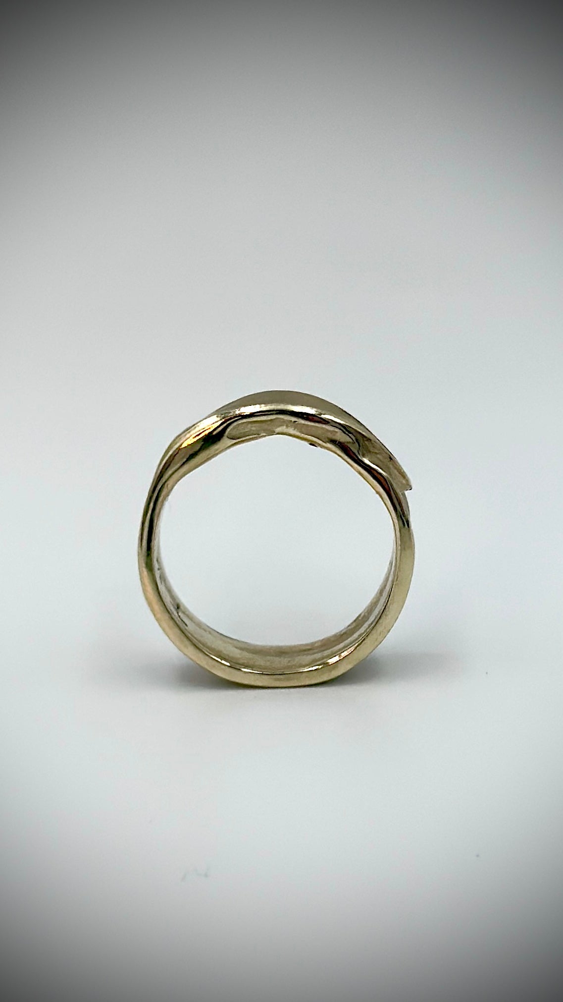 Front view of 9 carat gold feather ring displaying the open band form and smooth interior, lost wax cast by Marina Fox Fine Art