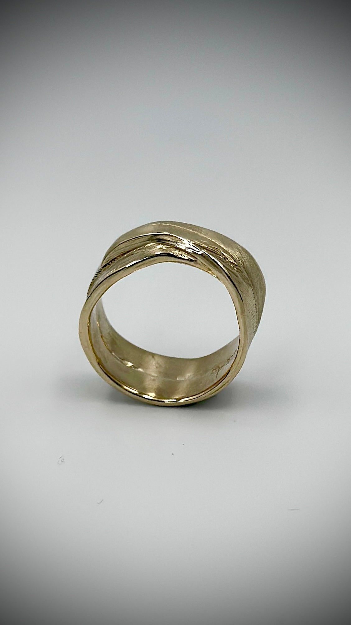 Front view of 9 carat yellow gold feather ring showing wide open band form, cast from a real bird's feather — Marina Fox Fine Art