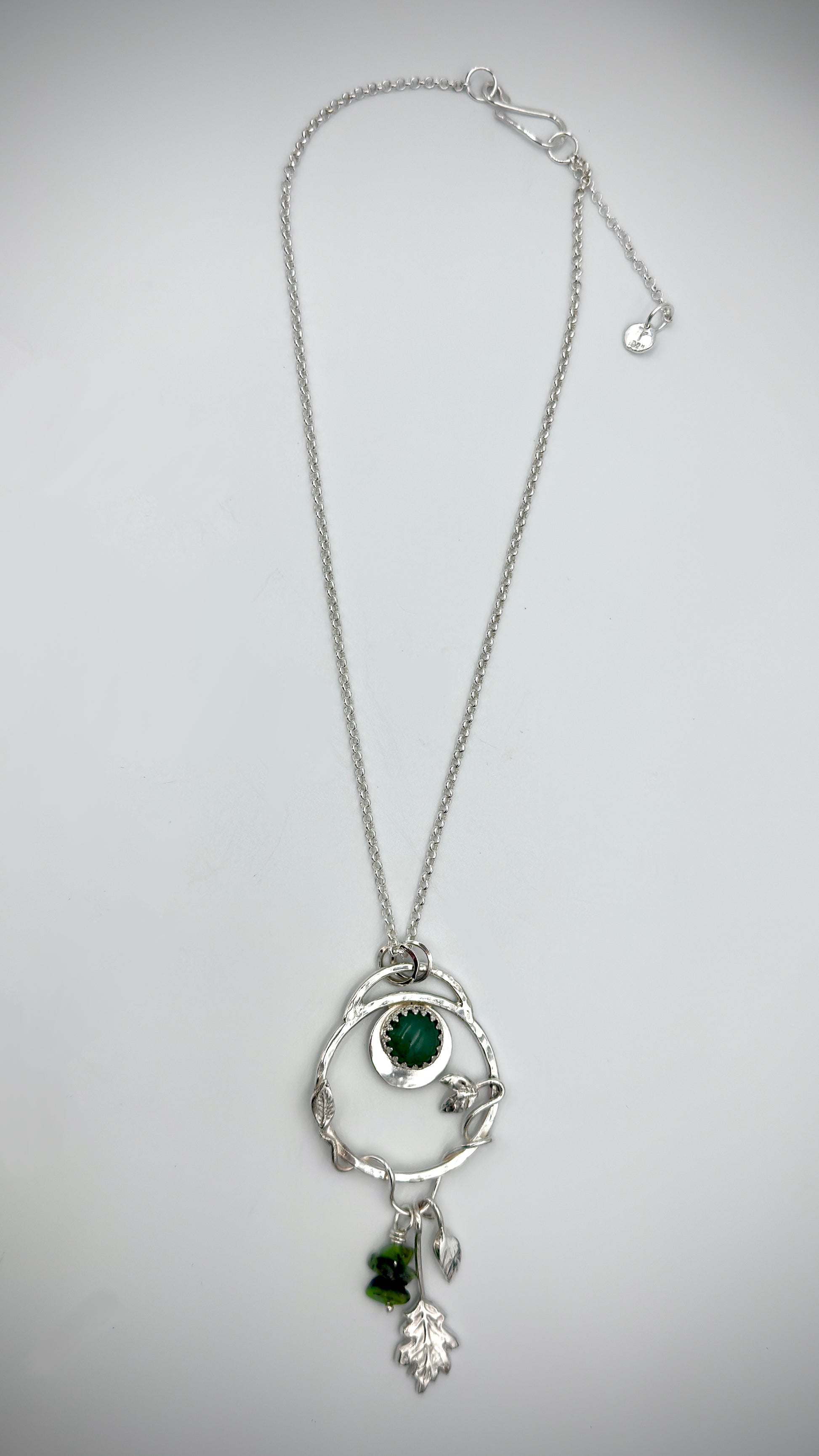 Full-length view of sterling silver Dryad pendant necklace with green aventurine cabochon and botanical leaf charms on belcher chain