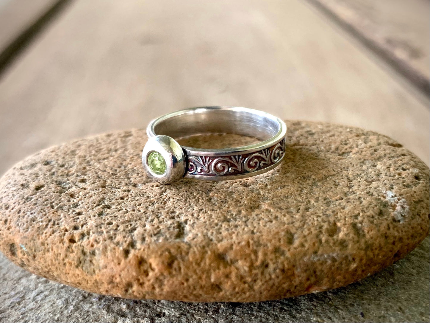 Inside view of sterling silver peridot ring showing scroll texture