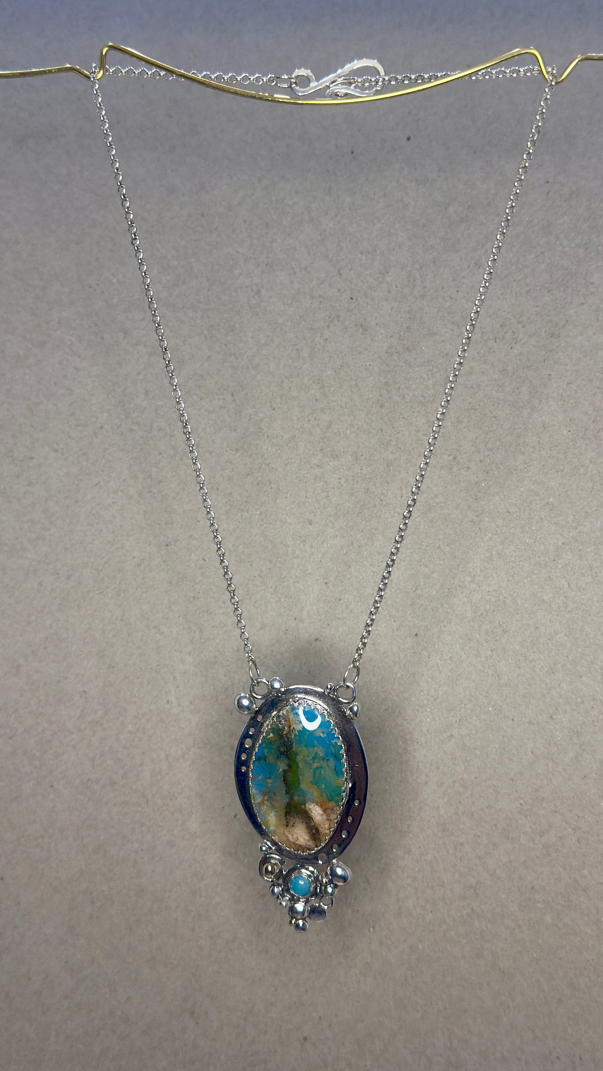 Necklace with a pendant on a plain background