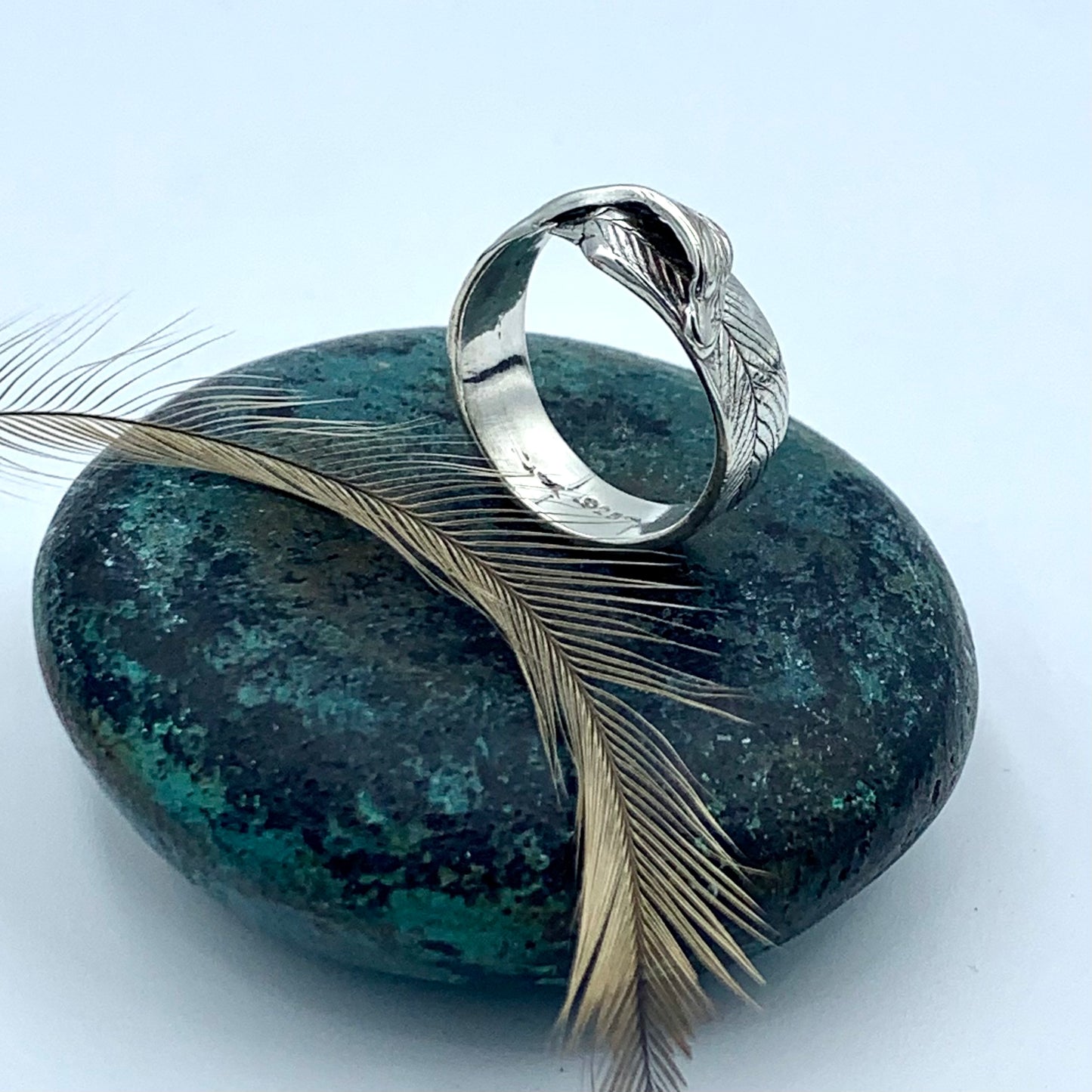 Sterling silver emu feather ring imprinted with a natural emu feather, showing detailed feather barb texture across the band
