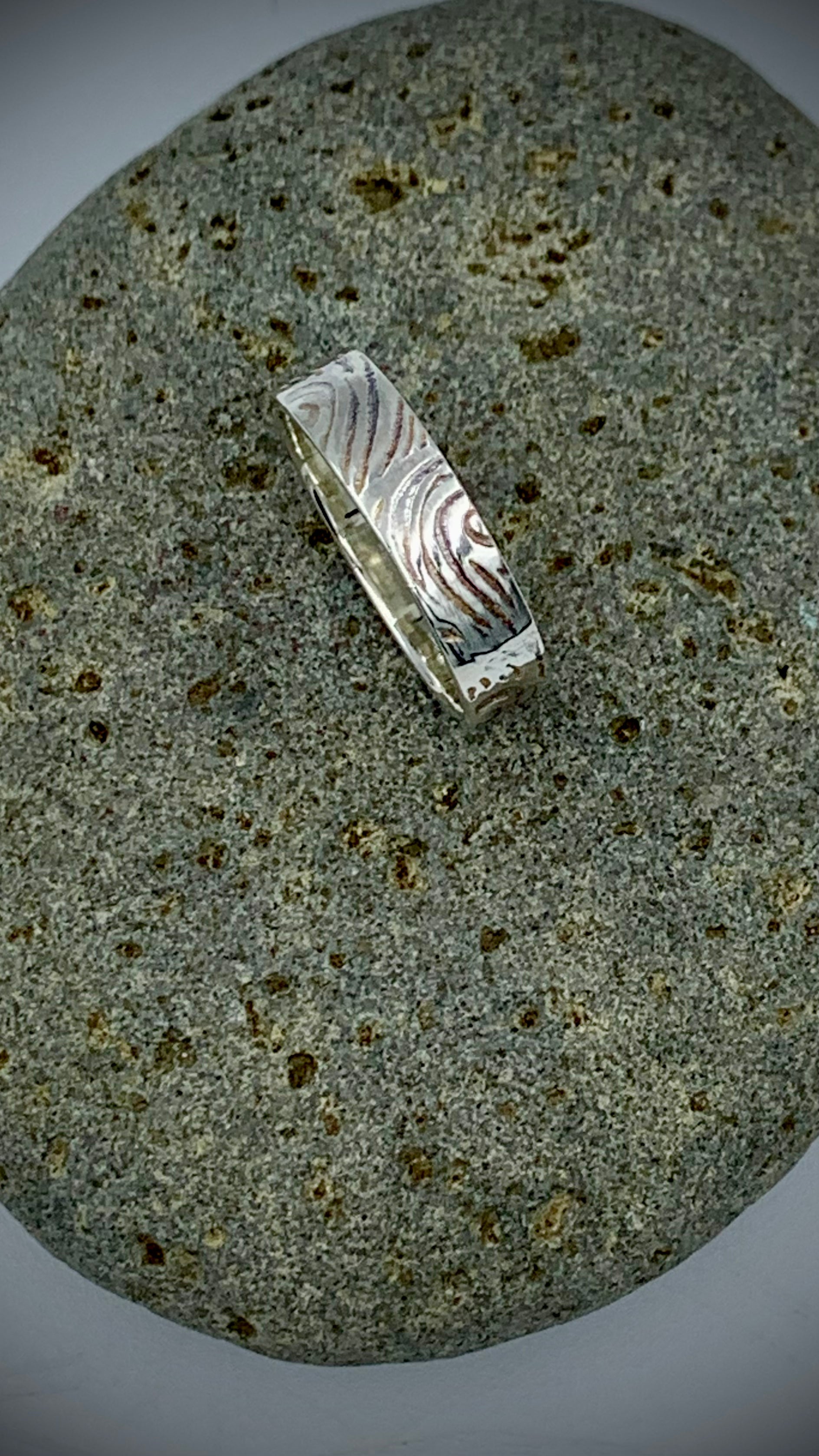Top view of handmade sterling silver band ring with flowing Wave texture