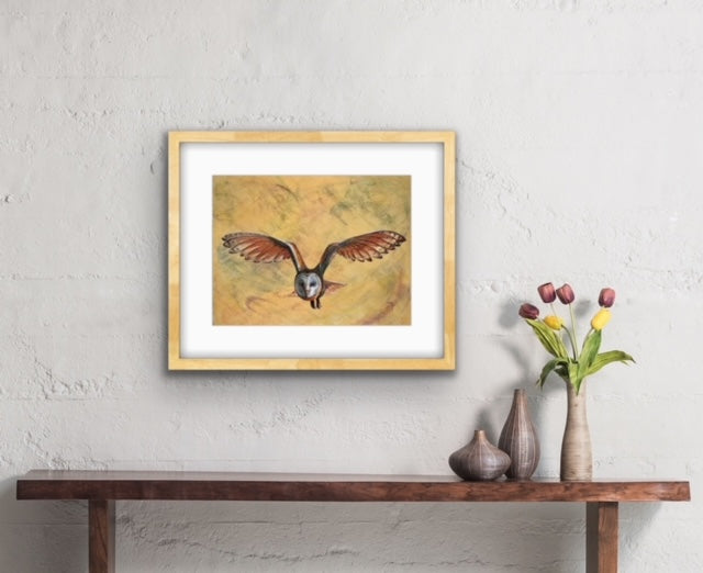 'Whoo Are You' Barn Owl fine art print by Marina Fox, framed in gold timber, displayed above a rustic wooden bench with ceramic vases and tulips against a textured white wall